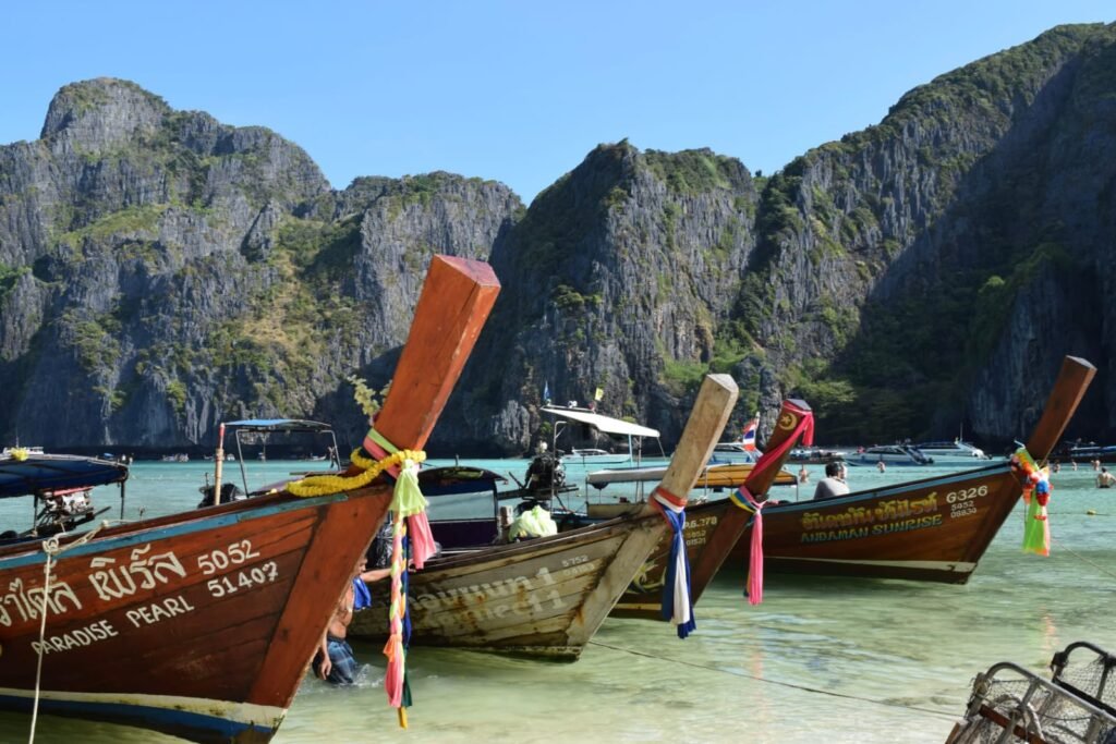 Thailand 7-day budget itinerary longtail boats on Phuket beach