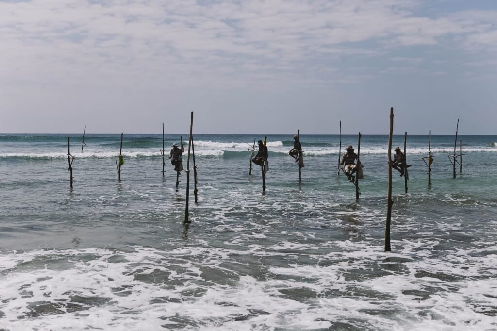 Traditional Sri Lankan stilt fishermen in ocean waves